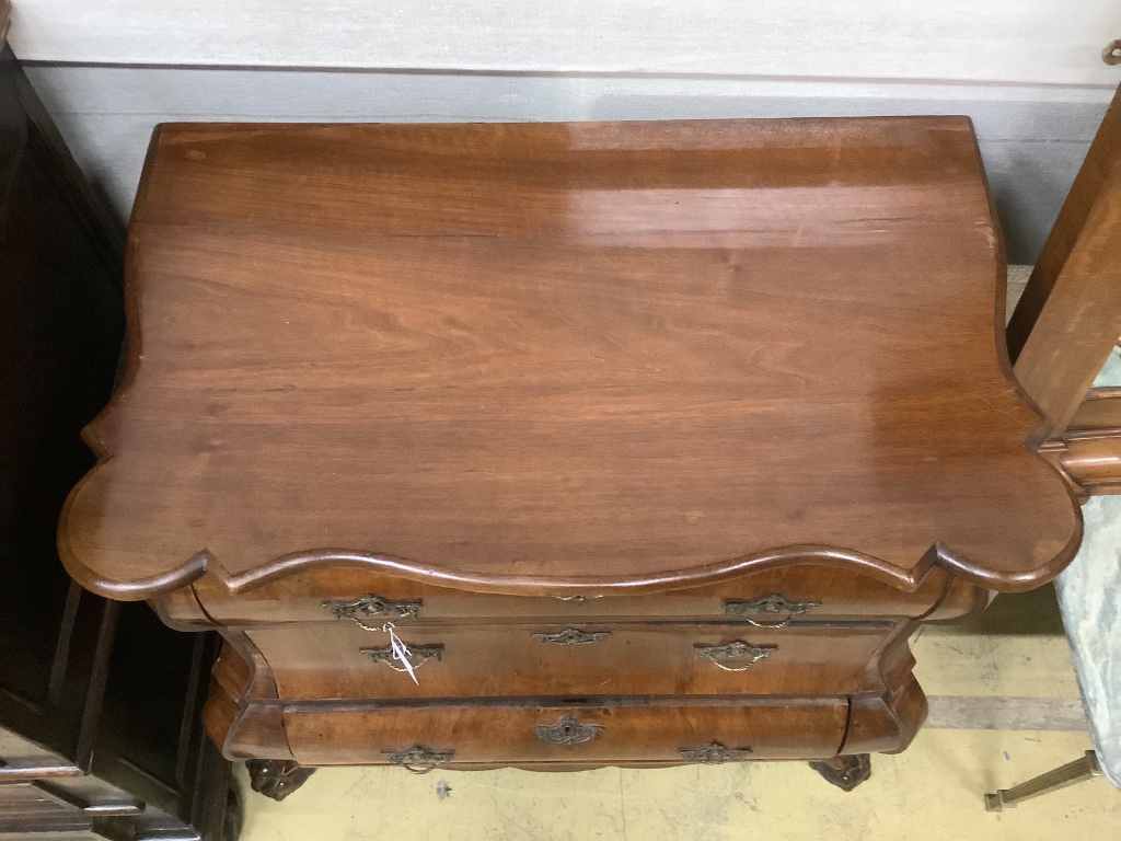 A 19th century and later Dutch mahogany bombe chest of three long drawers, raised on claw and ball feet